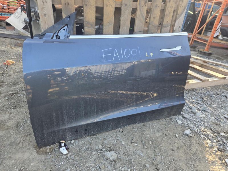 Used 2020 Tesla Model 3 front left door assembly grey — part view 1; Elite stock EA1001