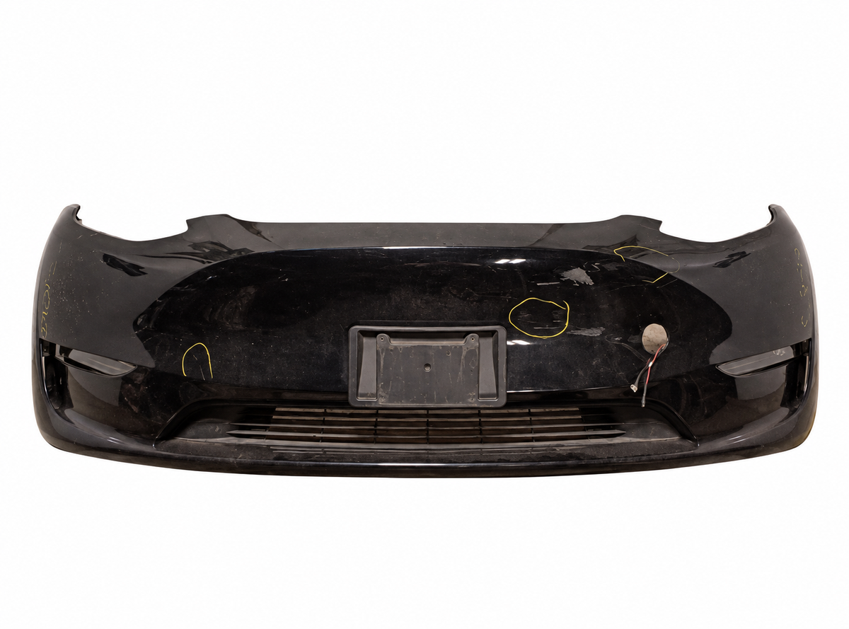 2024 Model Y black front bumper 6G1645; white background; actual tears, scuffs and missing components retained